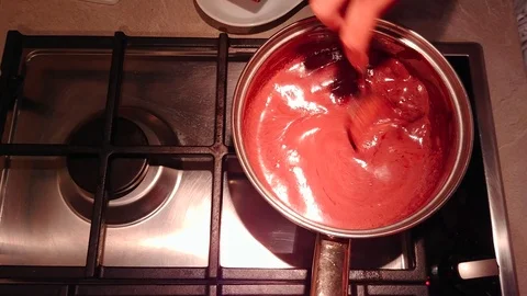 Mix the chocolate in the pot. Top view Stock Footage 94940327