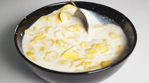Mix cornflakes in milk by spoon Stock Footage 63093063