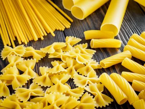 Mix of different kind of paste - spaghetti, tortiglioni, cannelloni, farfalle Stock Photos