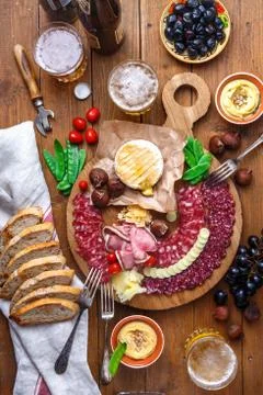 Mix of different snacks and appetizers: sausage, bread, olives, cheese Stock Photos