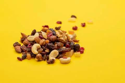 Mix of dried fruits and nuts on a yellow background Stock Photos