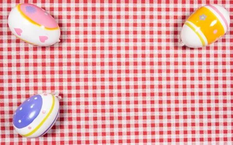 Mix of easter eggs of all colors and sizes on a background of red and white g Stock Photos