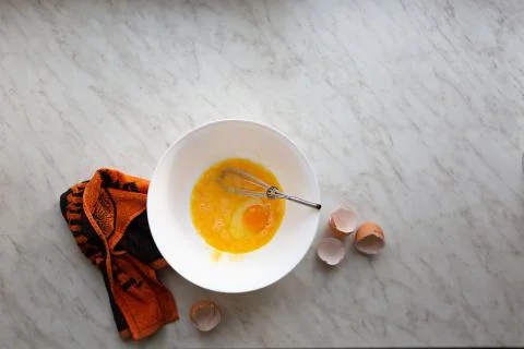 Mix eggs for omelette or baking banana bread on a light table by the window,  写真素材