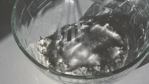 Mix flour and sugar with a mixer. Slow mo Video stock 75377953