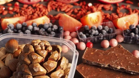 Mix of fresh fruits berries nuts, chocolate rich with resveratrol raw food ingre Stock Footage 113064853