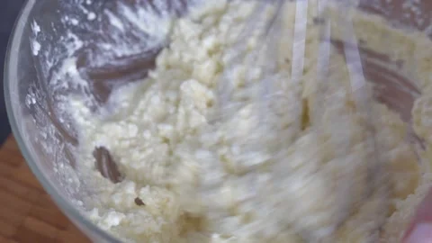 Mix the ingredients for the dough with a whisk. Close-up, top view. Stock Footage 303404332