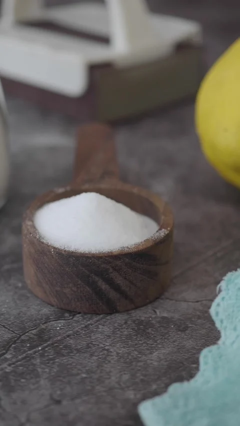 Mix lemon and baking soda for a natural cleaning solution in the kitchen Stock Footage 340442297