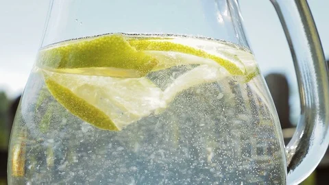 Mix lemon or lime water with spoon Stock Footage 94908099