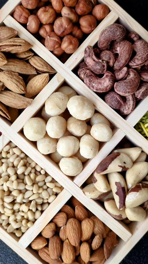 Mix of macadamia, pine, cashew, hazelnut, peanut, pistachio nuts Stock Footage 303622817