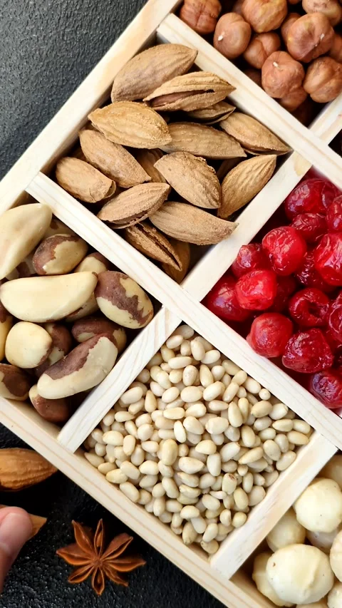 Mix of macadamia, pine, cashew, hazelnut, peanut, pistachio nuts Stock Footage 303622834