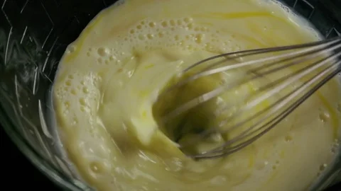 Mix a mixture of milk and egg in a bowl. Slow motion Video stock 75534651