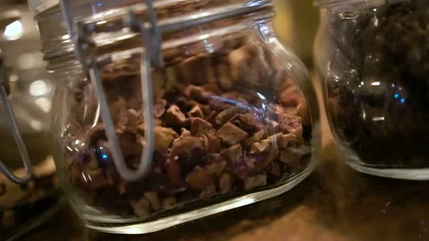 Mix of nuts in the glass jars, on the table. Close up Stock Footage 104154696