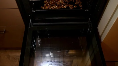 Mix nuts. Hands puts nuts. Assorted nuts. Man puts nuts in oven Stock Footage 87699380