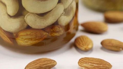 Mix of nuts in honey Stock Footage 124681114