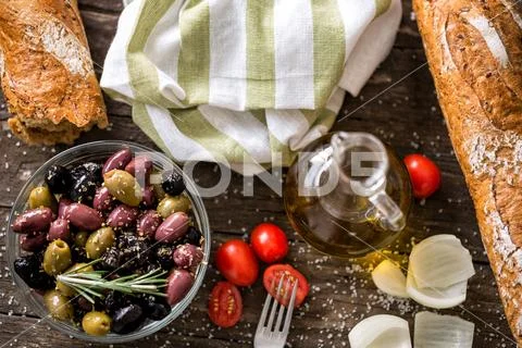 Mix of olives for salad in oil with spices. Stock Photos