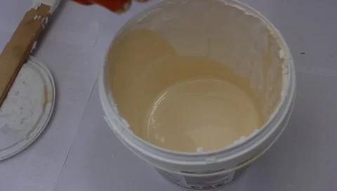 Mix the paint by adding a darker tone to it Stockbeeldmateriaal 94914917