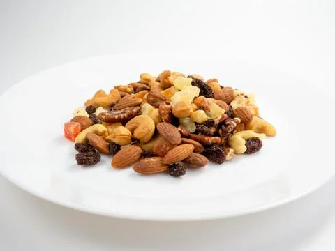 Mix of various nuts and dried fruit on white, Almonds, Raisins, Nuts, top vie Stock Photos
