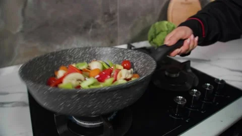 Mix the vegetable mixture in a frying pan1 Video stock 268576670
