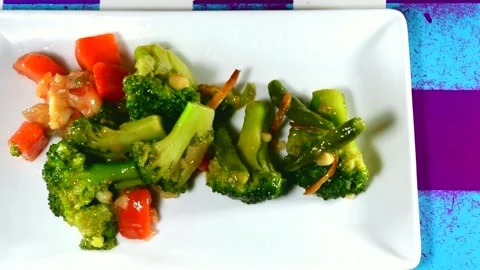 Mix vegetables serving on white plate. Vegetables for dinner 動画素材 137029449