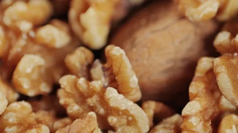 Mix of walnuts in red plate close-up macro. Walnut in shell, walnut without Video stock 256857532