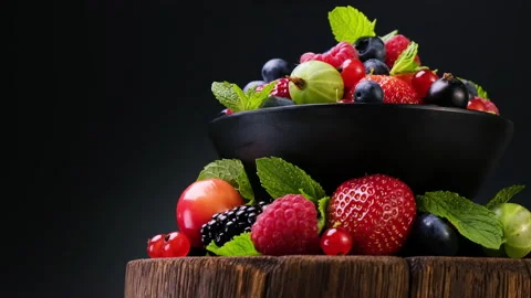 Mix of wild berries on black background, 4K UHD video footage Video stock 135411786