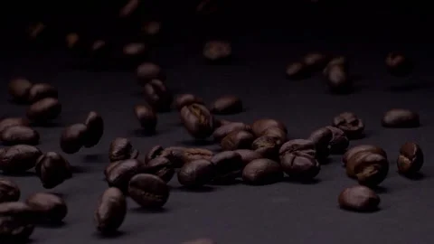 Mixed and tossed. Slow motion shot of roasted brown coffee beans rolling Stock Footage 147413182