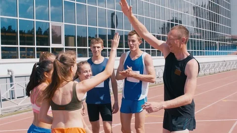 Mixed athletic team congratulating each other after win Stock Footage 113466226