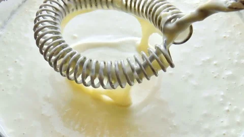 Mixed batter by hand mixer in the mixing bowl Stock Footage 79230400