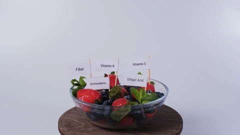 Mixed berries marked with nutrient labels Video stock 345975853