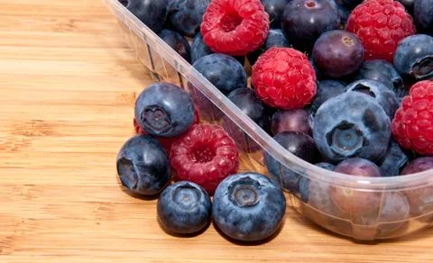 Mixed berries in plastic box - macro view Stock Photos