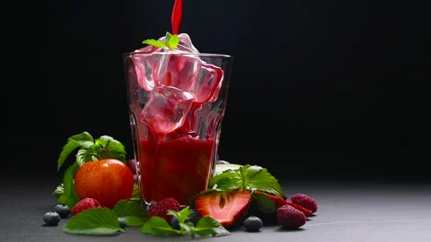 Mixed berry and beetroot pouring into tall glass with surrounding fruits Stock Footage 142267267