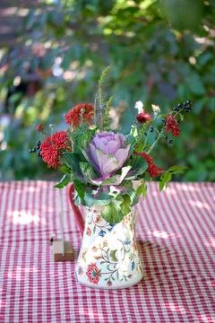 Mixed bouquet in ceramic vase on a checked tablecloth Stock Photos