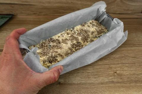 Mixed bread dough in a baking pan ready for the oven, for baking homemade b.. Stock Photos