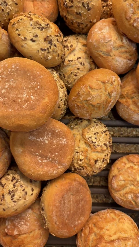 Mixed bread rolls with seeds and plain buns in bakery tray Stock Footage 317321308