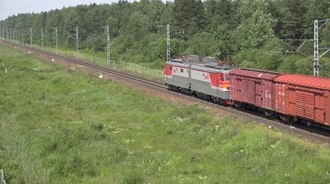 Mixed car type freight train hauled by electric locomotive Stock Footage 64574530