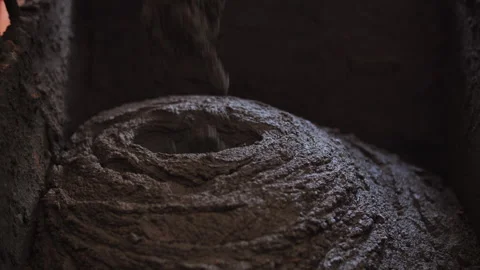 Mixed cement mortar is poured into a barrel Stock Footage 274720775