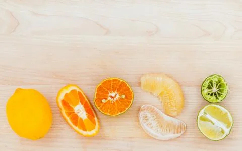 Mixed citruses fruit oranges, lemon and lime on wooden background with orange Stock Photos
