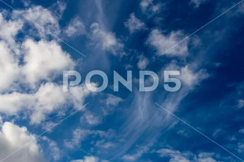 Mixed clouds closeup telephoto shot with polarizing effect. Stock Photos