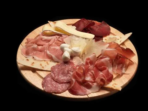 Mixed cold cuts and cheese on a wood dish Stock Photos