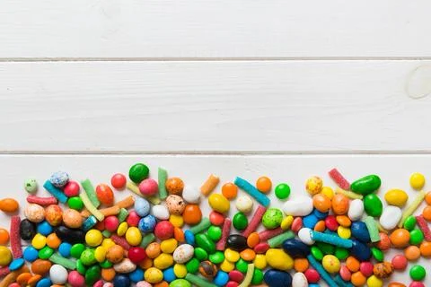 Mixed collection of colorful candy, on colored background. Flat lay, top vi.. Stock Photos