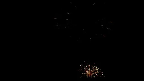 Mixed color fireworks explode during a festive night celebration Stock Footage 329676166