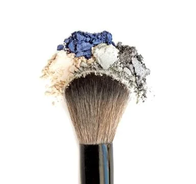 Mixed crushed make up eyeshadow with brush. Isolate on white. Stock Photos
