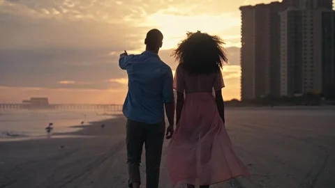 Mixed Diverse Couple Walks On Beach during Sunset East Coast Florida Carolina Stock Footage 280508434