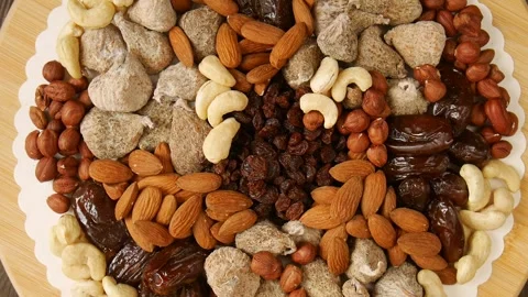 Mixed dried fruit nuts on a plate. Video stock 302920491