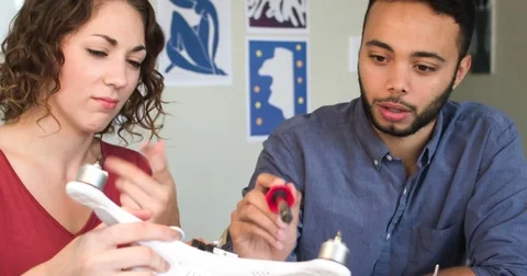 Mixed Ethnicity Young Software Engineers Wiring A Drone Robot In A Hip Startup Видео 82670029