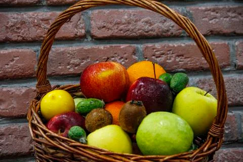 Mixed exotic fruit basket in brick background Stock Photos