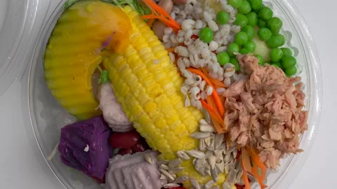 Mixed Fresh Salad In Disposable Plastic Box Rotating On White Background. Stockbeeldmateriaal 197781666