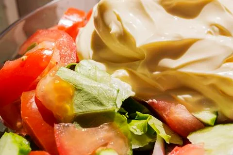Mixed fresh salad with white dressing, with big wooden spoon, suitable for ba Stock Photos