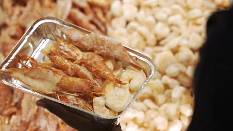 Mixed Frozen Prawns Being Selected into Foil Tray at Retail Seafood Bin Stock Footage 340048169