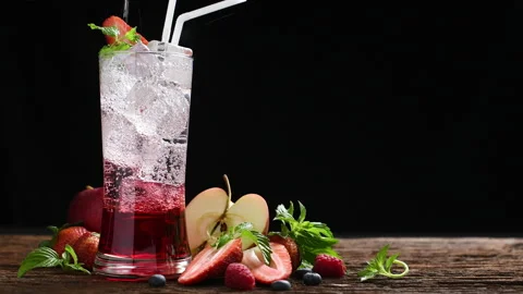 Mixed fruit juice with syrup and soda surrounded by fruits on wooden background 库存影片 143579144